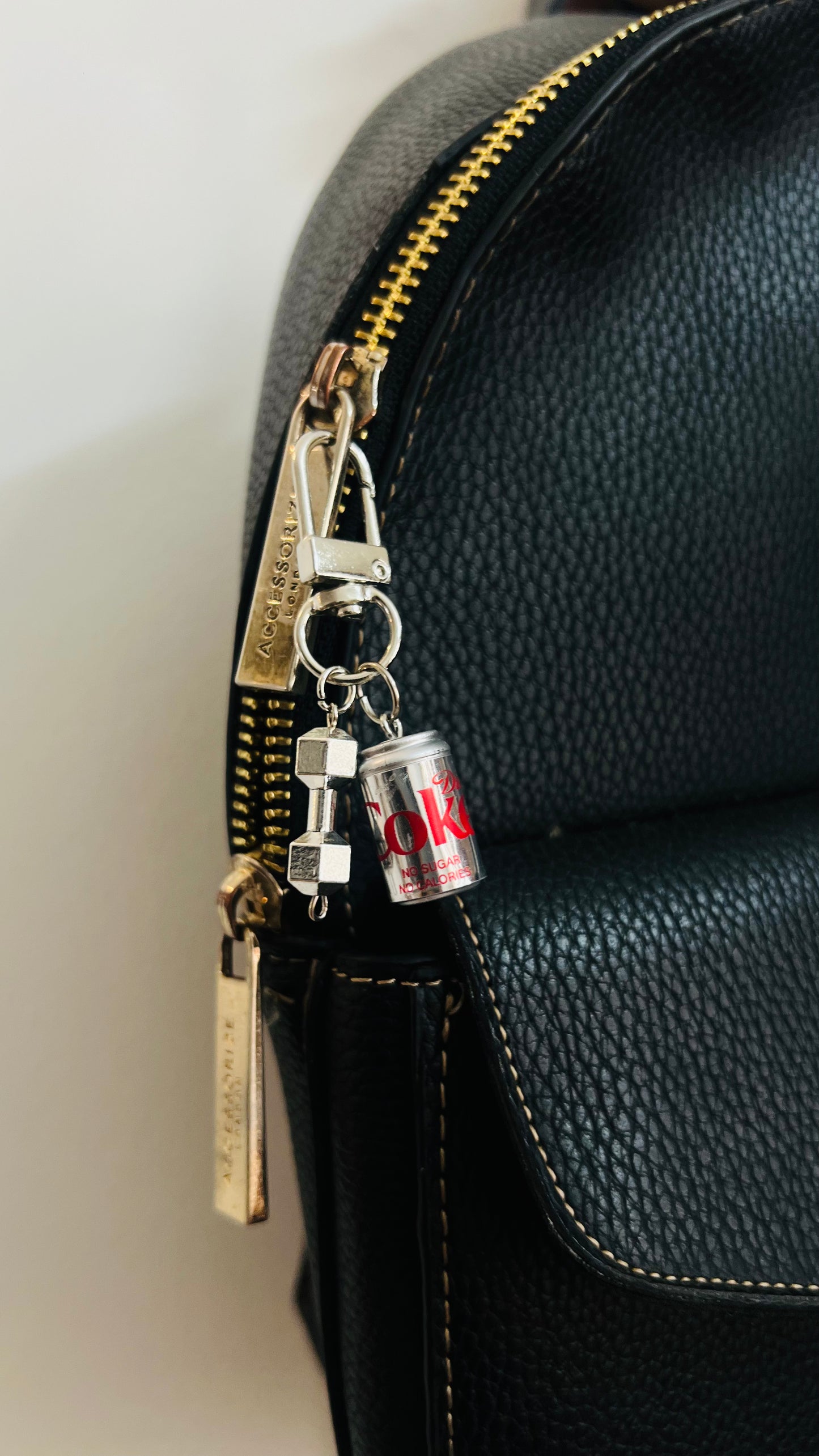 Silver metallic Diet Coke can charm with a dumbbell pendant on a D-hook bag clasp