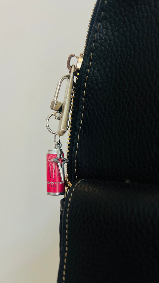Pink Monster Energy can charm with a silver star bling pendant on a bag clasp