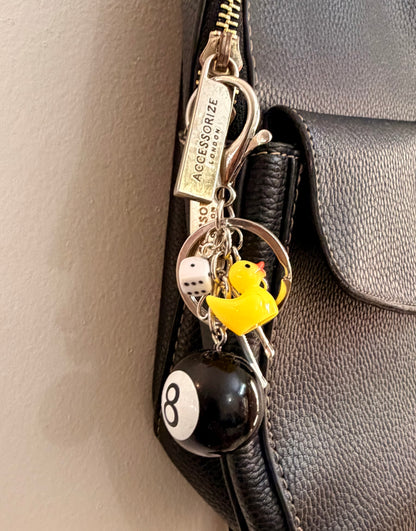 Lucky Break Bag Charm, black 8 ball with a yellow rubber duck and silver bow on a keyring