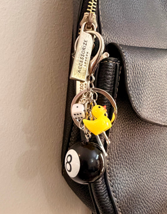 Lucky Break Bag Charm, black 8 ball with a yellow rubber duck and silver bow on a keyring