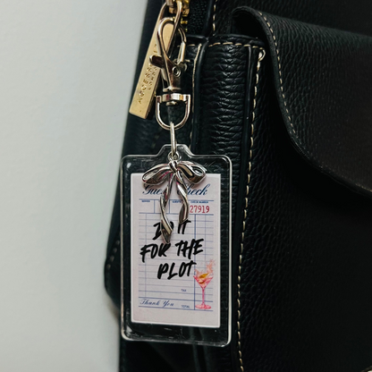Do It For The Plot acrylic receipt bag charm with a silver bow