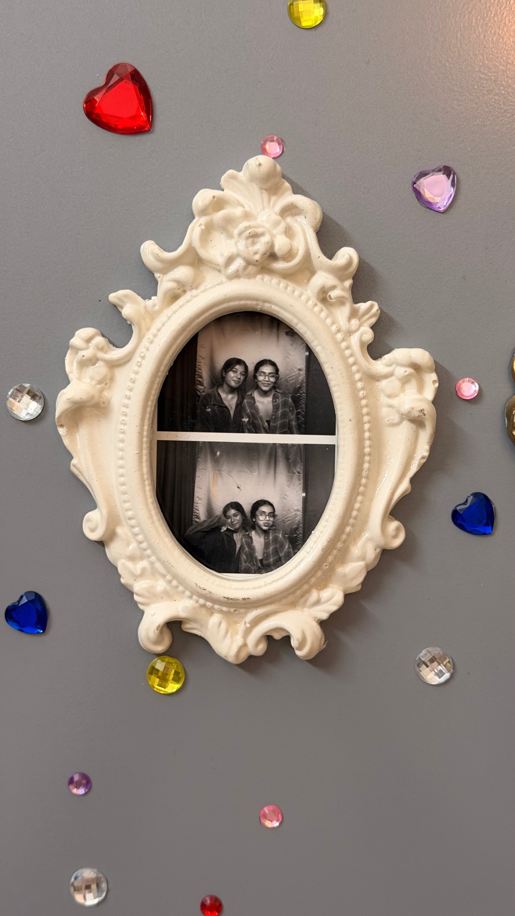 Antique Royal Magnetic Frame, white concrete baroque frame holding a black and white photo booth strip