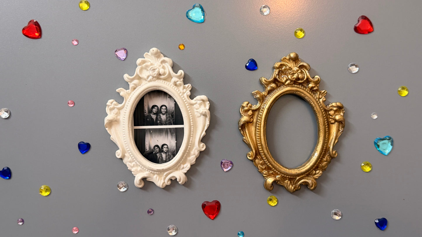 Antique Royal Magnetic Frame, white and gold concrete baroque frames on a fridge door, the white one holding a photo strip