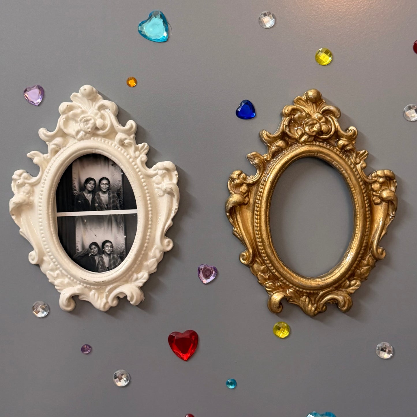 Antique Royal Magnetic Frame, close view of the white and gold concrete baroque frames on a fridge door