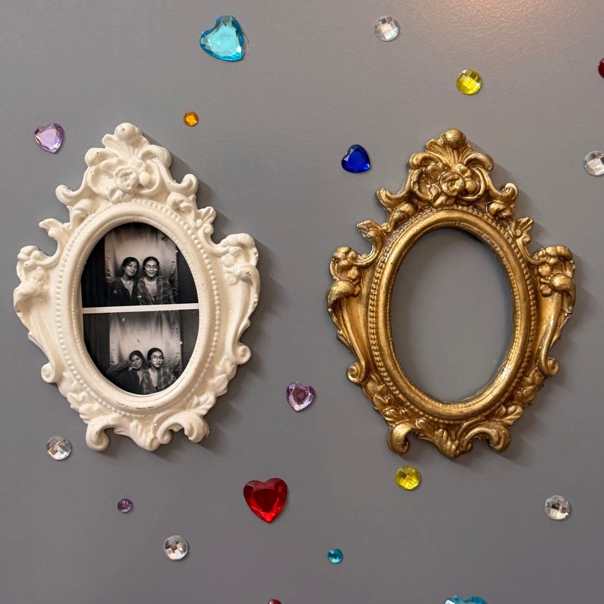 Antique Royal Magnetic Frame, close view of the white and gold concrete baroque frames on a fridge door