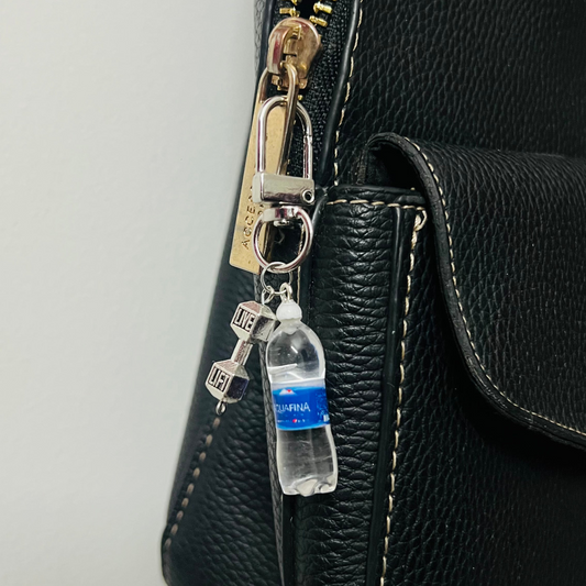 Aquafina water bottle bag charm with a silver dumbbell charm