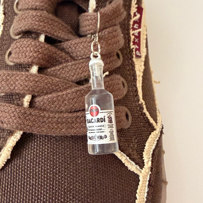Bacardi Shoe Charm, mini Bacardi rum bottle charm on the laces of a brown canvas sneaker