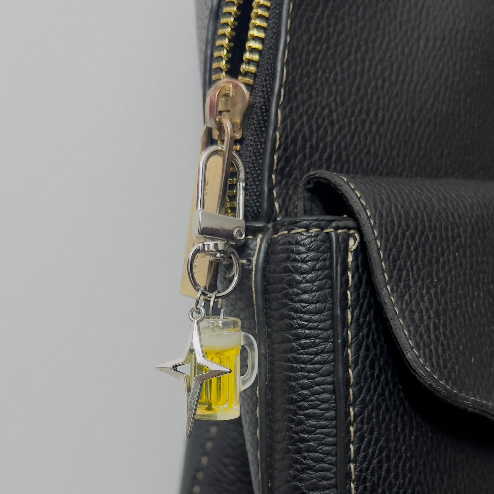 Beer mug bag charm with golden beer and a silver star charm