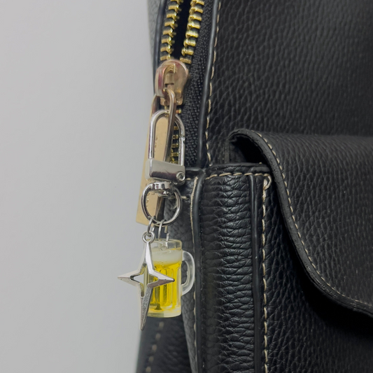 Beer mug bag charm with golden beer and a silver star charm