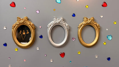 Bow and Blooms Magnetic Frame, three concrete oval frames side by side on a fridge door, gold with a photo, silver and gold