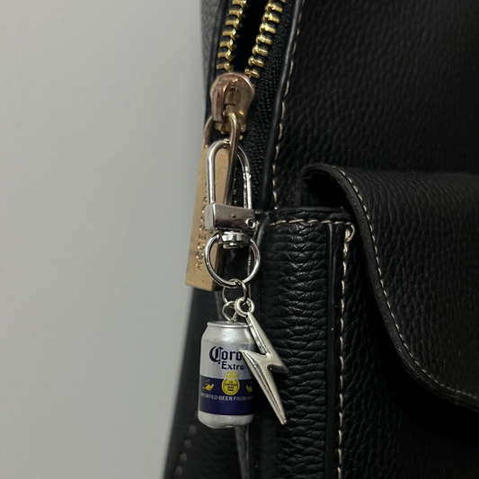 Corona Extra beer can bag charm with a silver thunderbolt charm