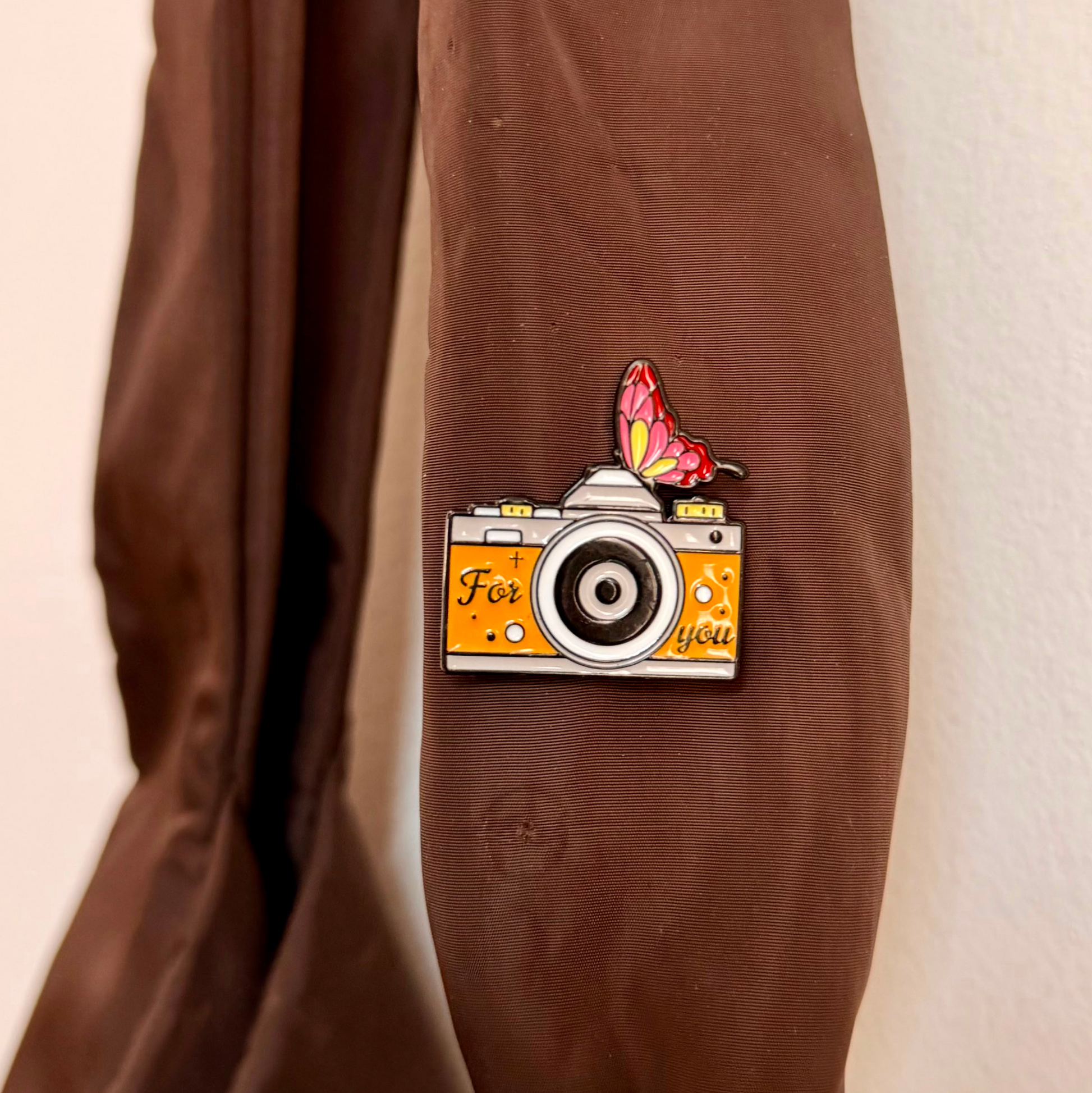 Caught in a Moment Enamel Pin, orange retro film camera reading For you with a butterfly on top