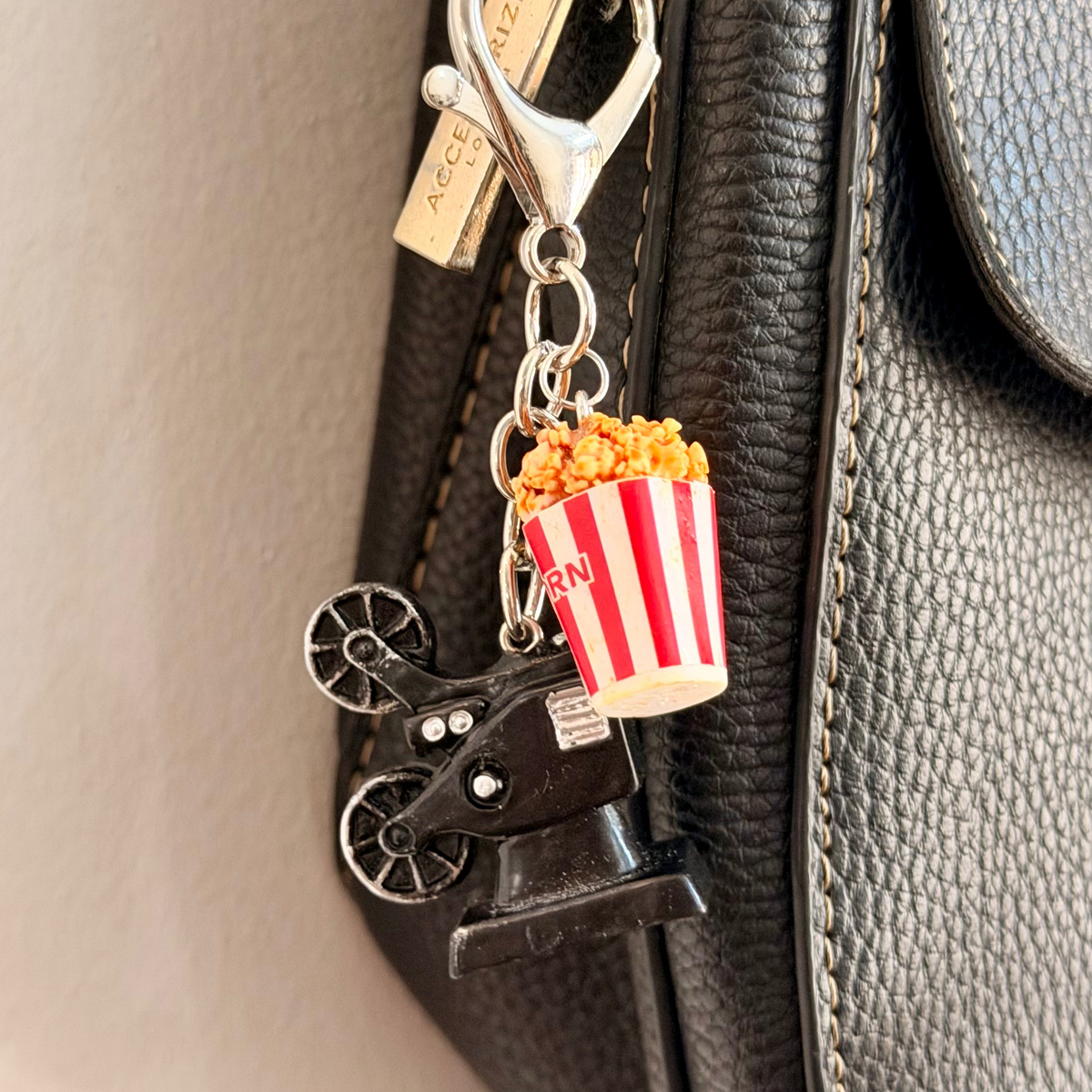 Certified Movie Buff, a vintage film projector with a striped popcorn box.