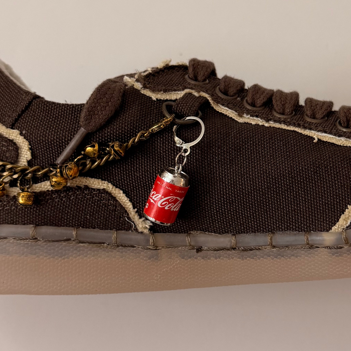 Coca-Cola Shoe Charm, mini red Coca-Cola can charm on the laces of a brown canvas sneaker