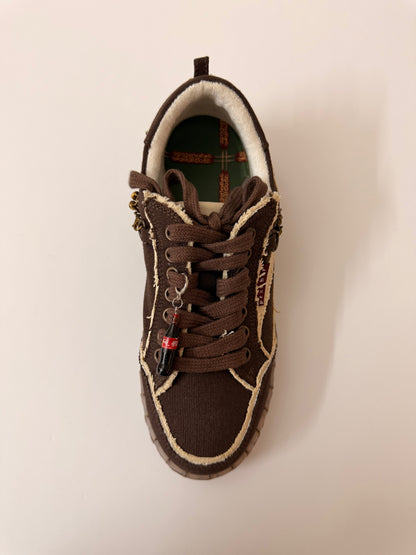 Coke Bottle Shoe Charm, mini Coca-Cola glass bottle charm on the laces of a brown canvas sneaker