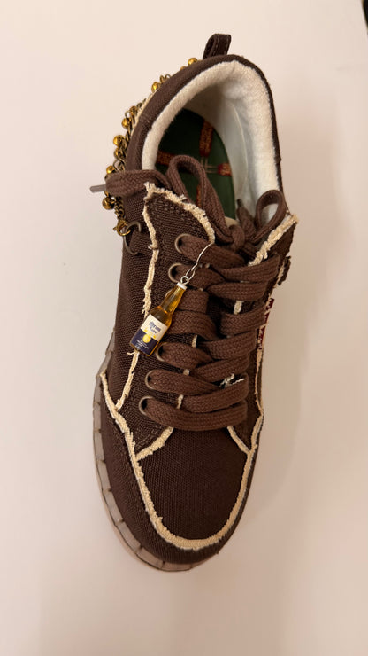 Corona Shoe Charm, mini Corona Extra beer bottle charm on the laces of a brown canvas sneaker