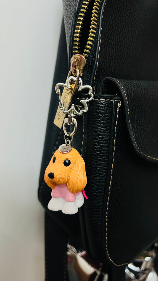 Golden puppy bag charm dressed in a pink outfit (view 2)