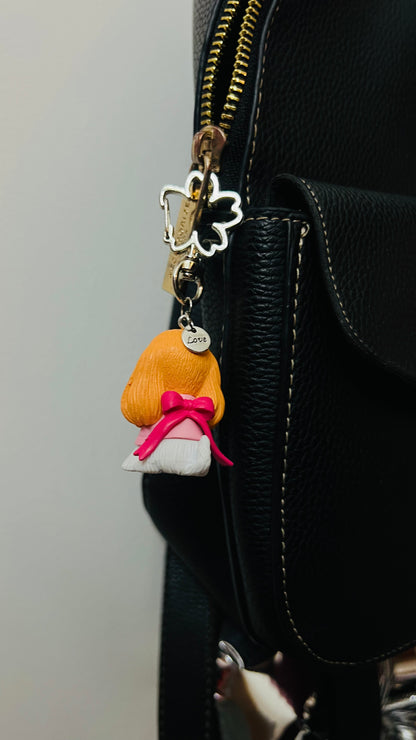 Golden puppy bag charm dressed in a pink outfit (view 3)