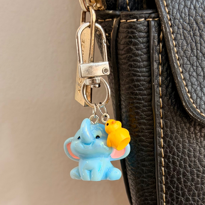 Ducky and Dumbo, a blue baby elephant with a yellow duckling on its trunk.