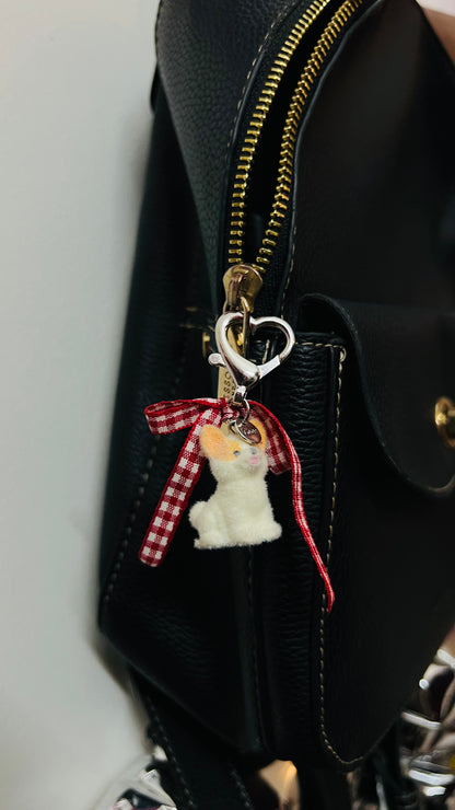 Furry puppy bag charm with a red gingham bow (view 2)