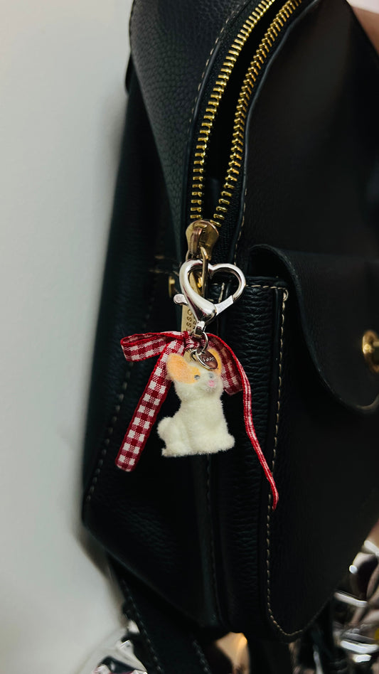 Furry puppy bag charm with a red gingham bow (view 2)