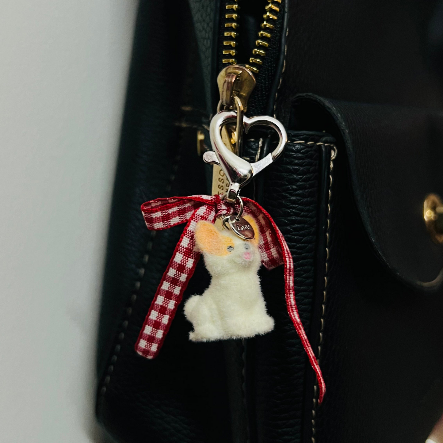 Furry puppy bag charm with a red gingham bow