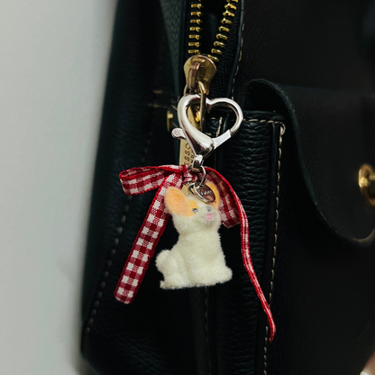 Furry puppy bag charm with a red gingham bow