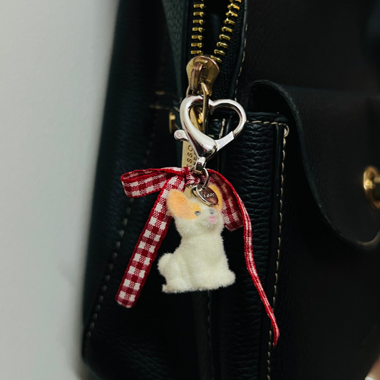 Furry puppy bag charm with a red gingham bow