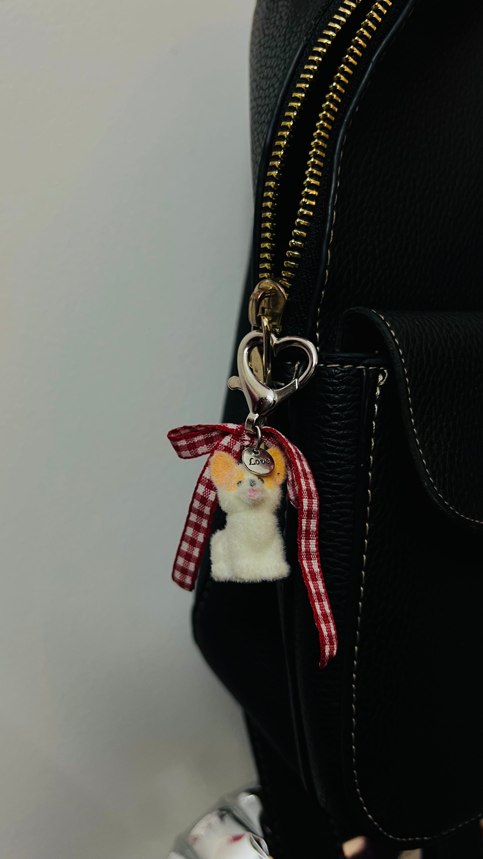 Furry puppy bag charm with a red gingham bow (view 3)