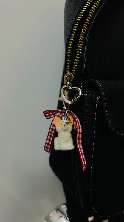 Furry puppy bag charm with a red gingham bow (view 3)