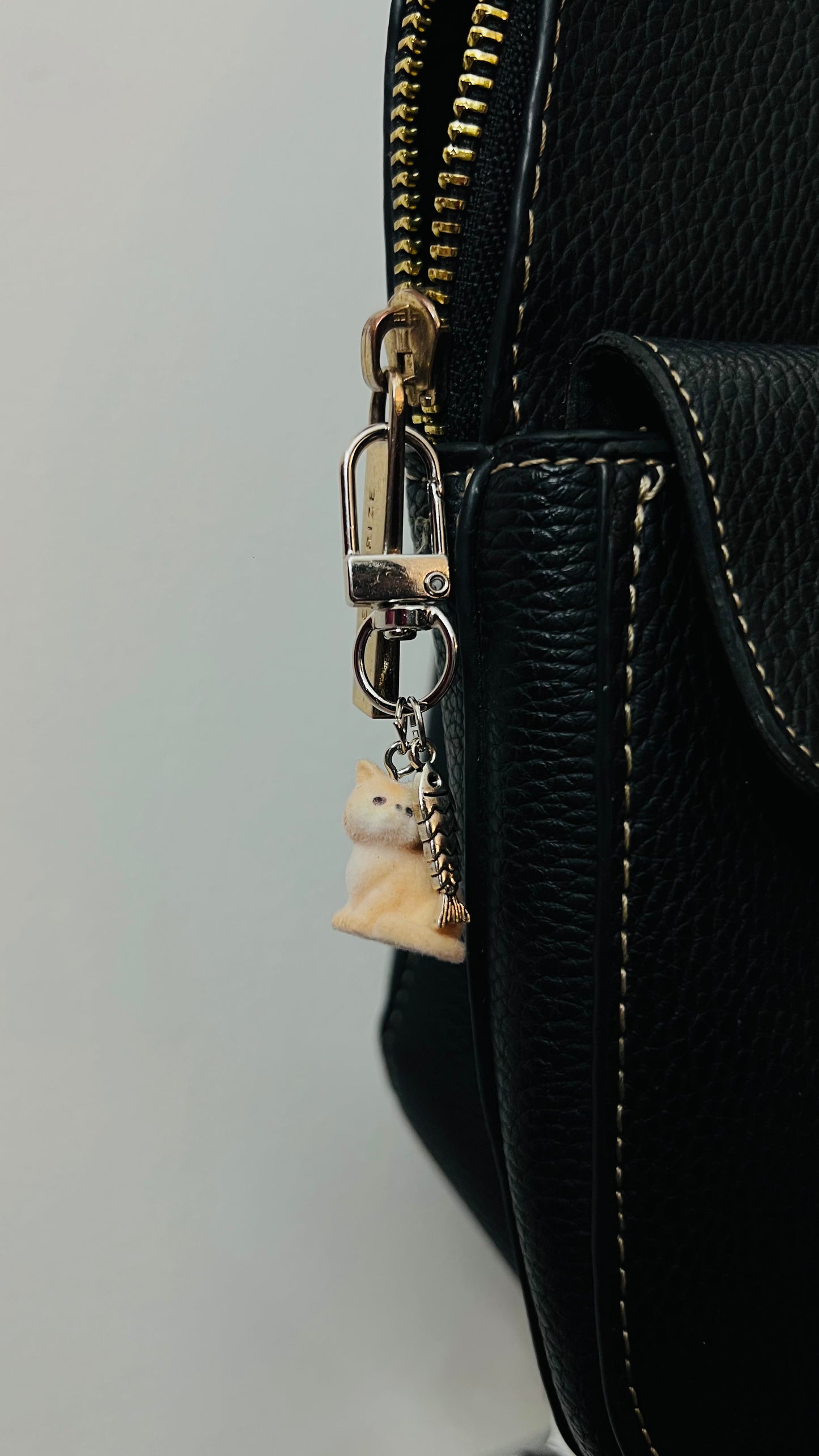 Furry orange cat bag charm with a silver fish charm (view 3)