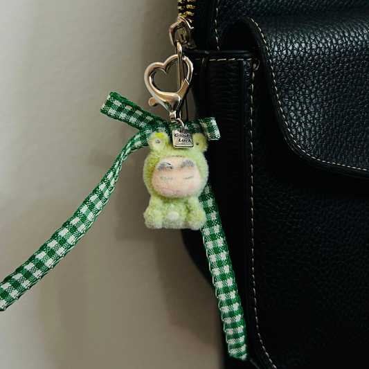 Furry Shinchan bag charm in a green dinosaur costume