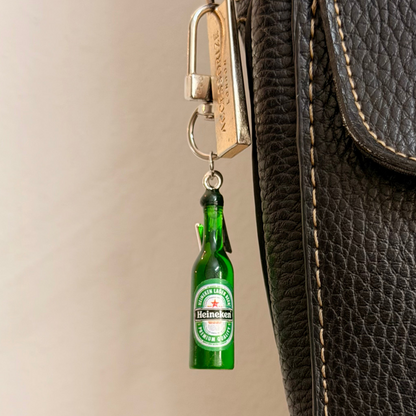 Heineken with Thunderbolt, a miniature green beer bottle with a silver thunderbolt charm.