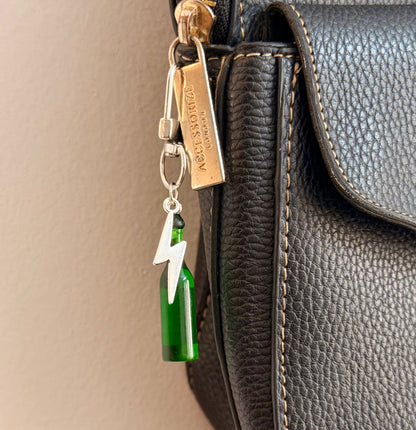 Heineken with Thunderbolt, a miniature green beer bottle with a silver thunderbolt charm shown from another angle.