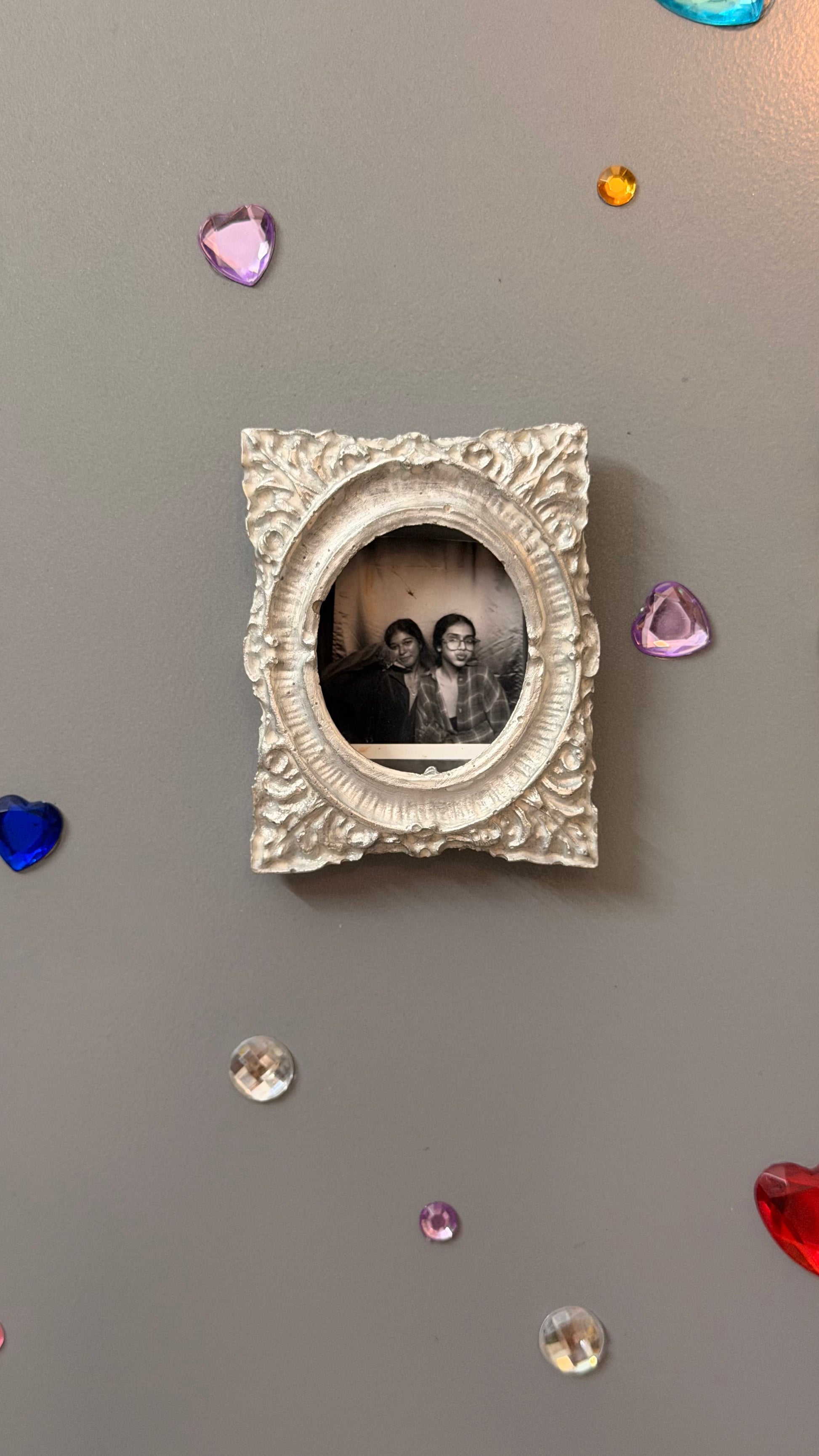 Hold This Moment Magnetic Frame, silver concrete frame with an oval opening holding a black and white photo