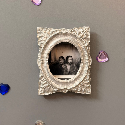 Hold This Moment Magnetic Frame, silver concrete frame with an oval opening holding a black and white photo