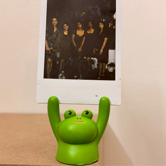 Frog Photo Holder, green frog holding a polaroid up in its raised arms