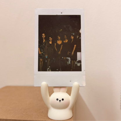 White Rabbit Photo Holder, white bunny holding a polaroid up in its raised arms