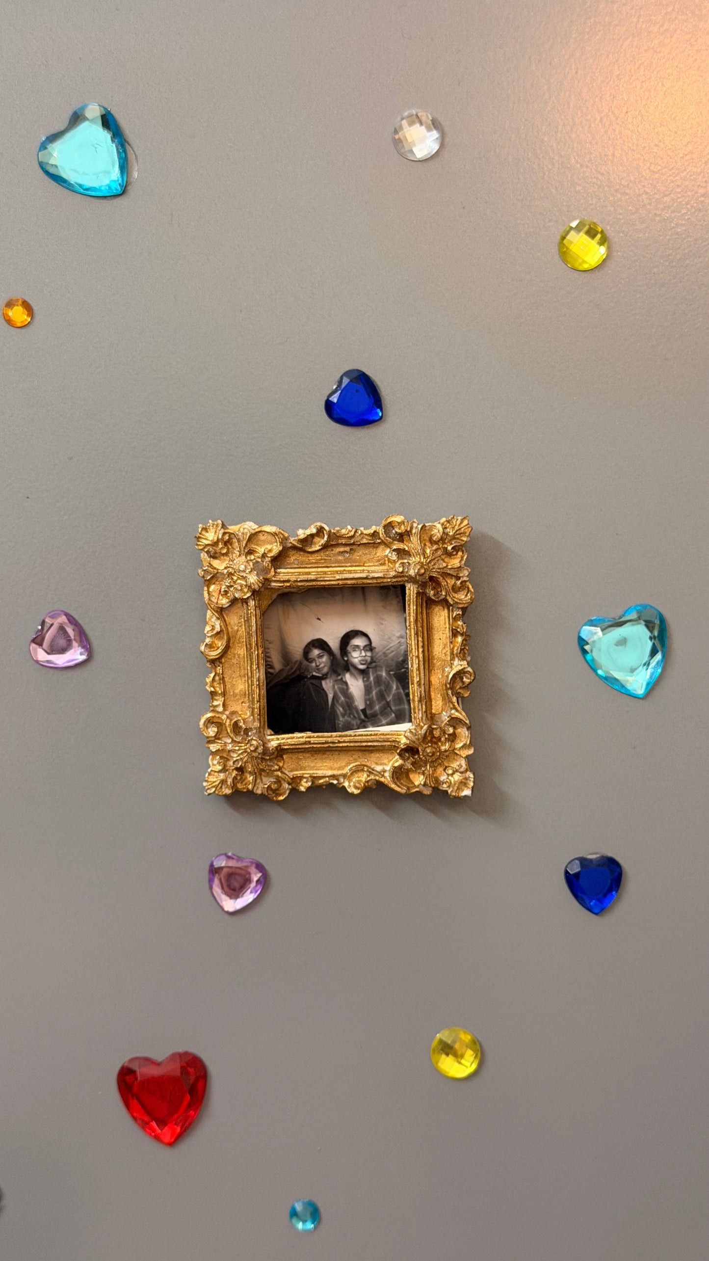 The Nostalgic Magnetic Frame, gold concrete square frame holding a black and white photo on a fridge door