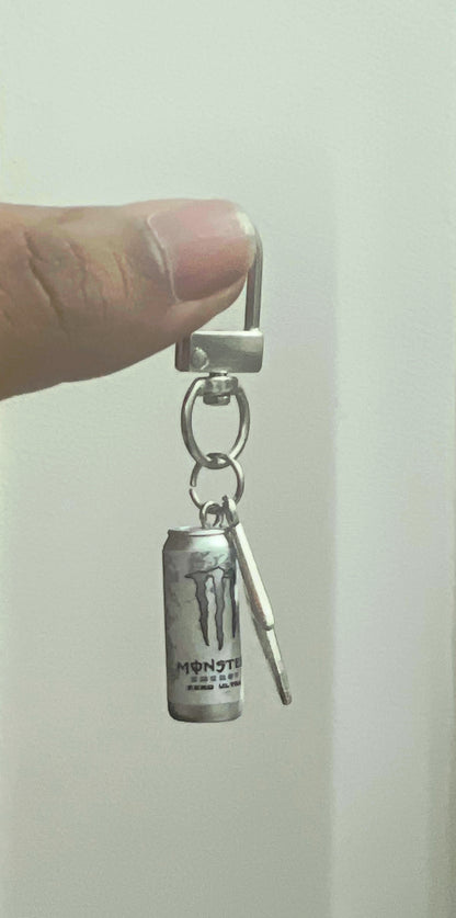 White Monster Energy can bag charm with silver lightning bolt held on a metal clasp
