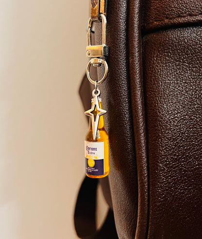 Corona Extra mini bottle bag charm with silver star on a D-hook, brown leather bag
