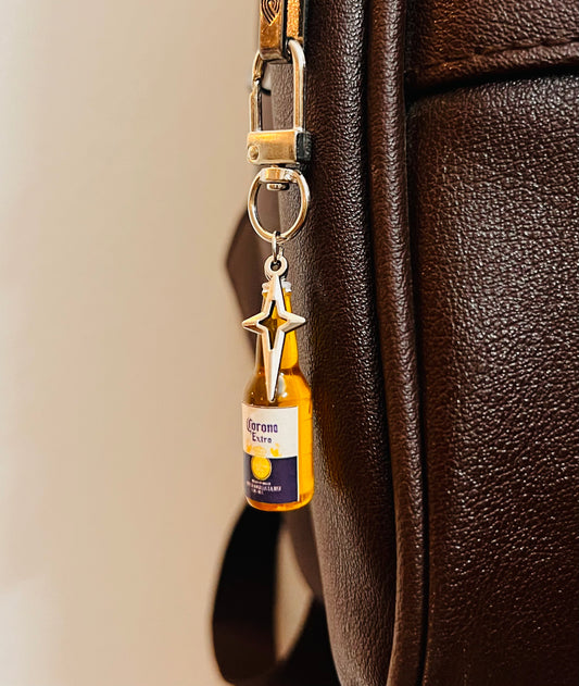 Corona Extra mini bottle bag charm with silver star on a D-hook, brown leather bag