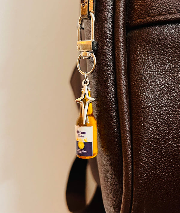 Corona Extra mini bottle bag charm with silver star on a D-hook, brown leather bag