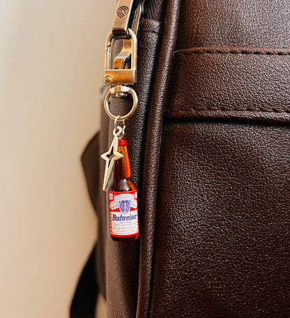 Budweiser beer bottle bag charm with silver star on a D-hook clasp, brown leather bag