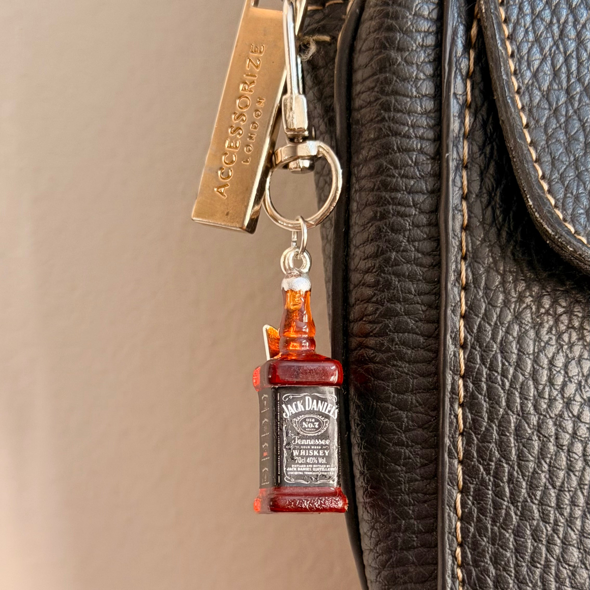 Jack daniels with Thunderbolt, a miniature whiskey bottle with a silver thunderbolt charm.