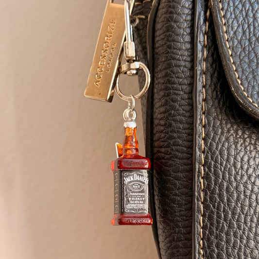 Jack daniels with Thunderbolt, a miniature whiskey bottle with a silver thunderbolt charm.
