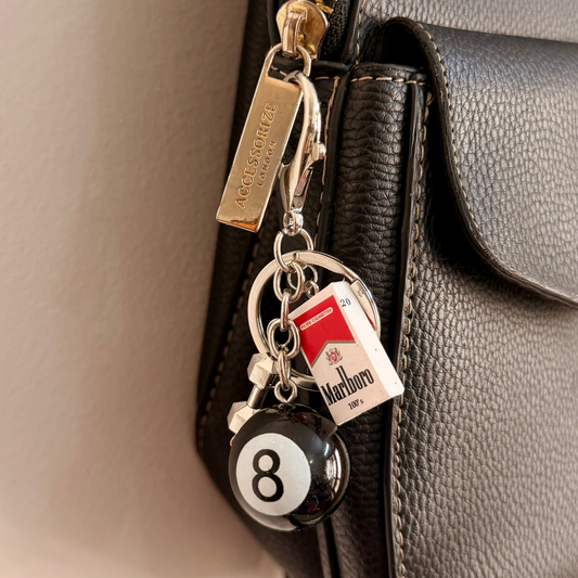 Lucky 8, a black 8 ball and a miniature cigarette pack on a silver keyring.
