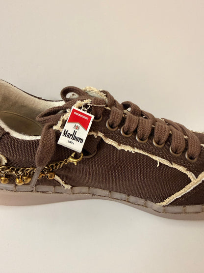 Marlboro Shoe Charm, mini Marlboro 100's pack charm on the laces of a brown canvas sneaker
