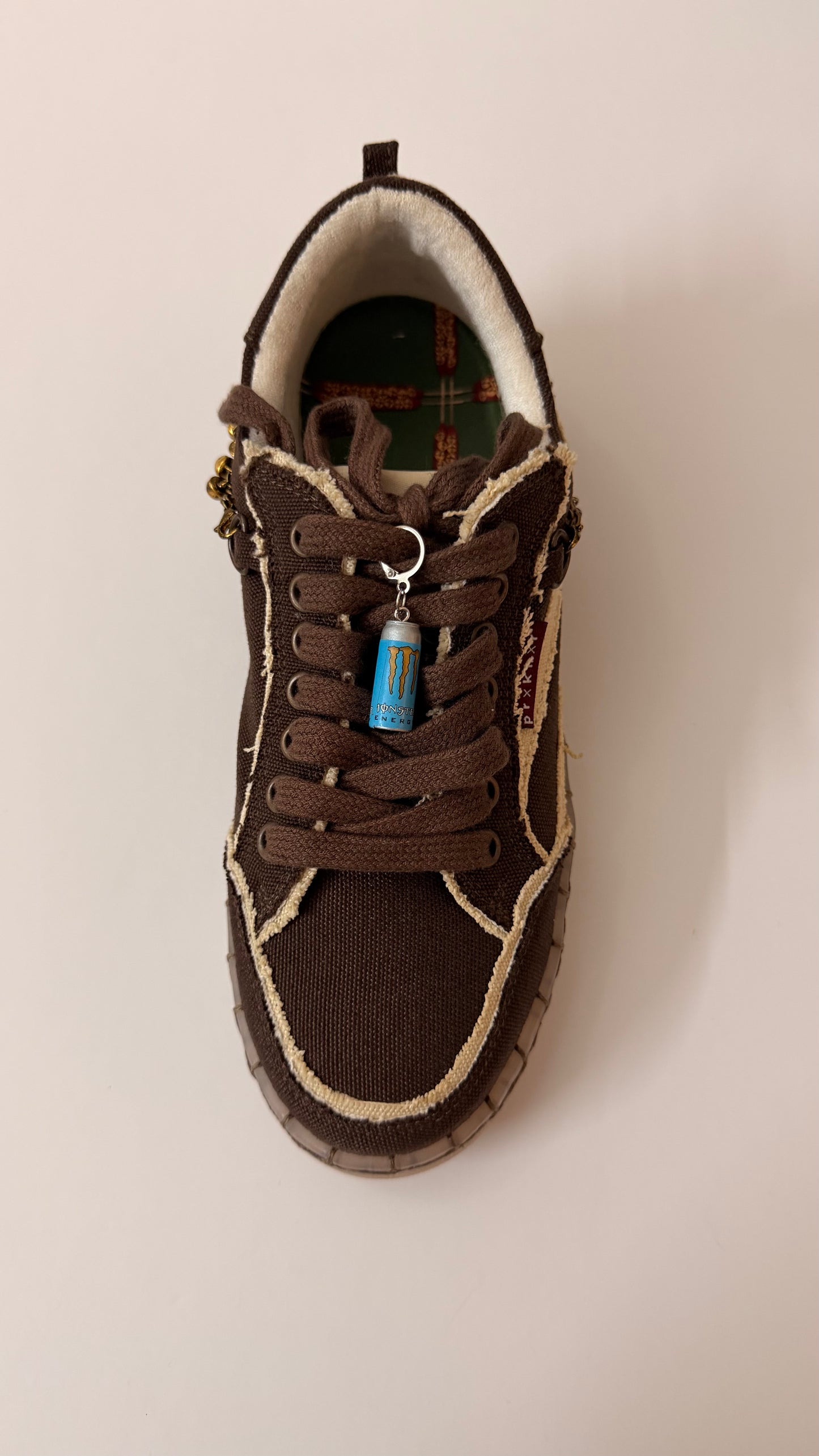 Blue Monster Energy Shoe Charm, mini light blue Monster Energy can charm on the laces of a brown canvas sneaker