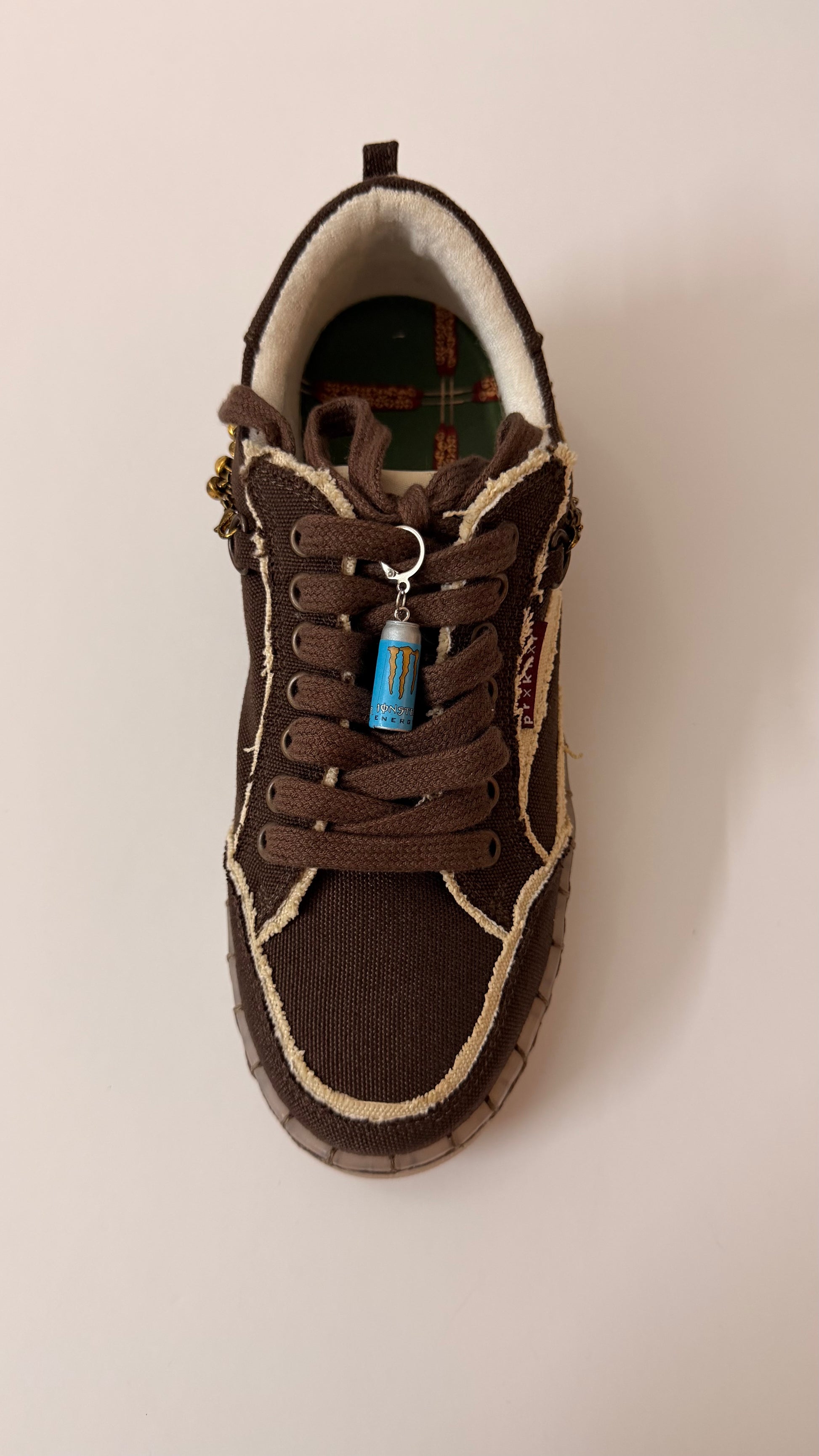 Blue Monster Energy Shoe Charm, mini light blue Monster Energy can charm on the laces of a brown canvas sneaker